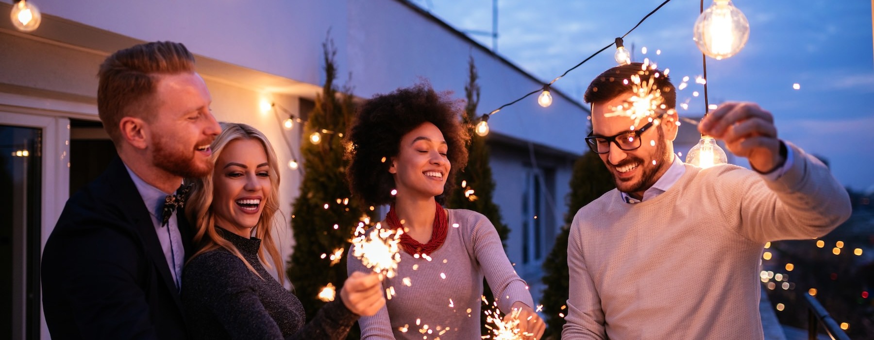 a group of people holding sparklers