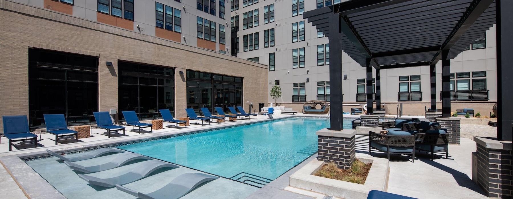 a swimming pool with chairs around it