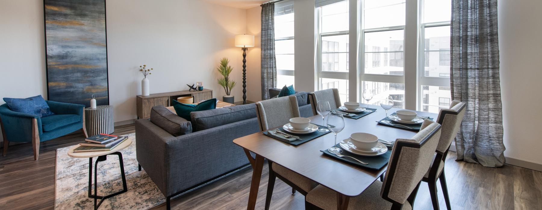 a living room with a couch, tables and chairs